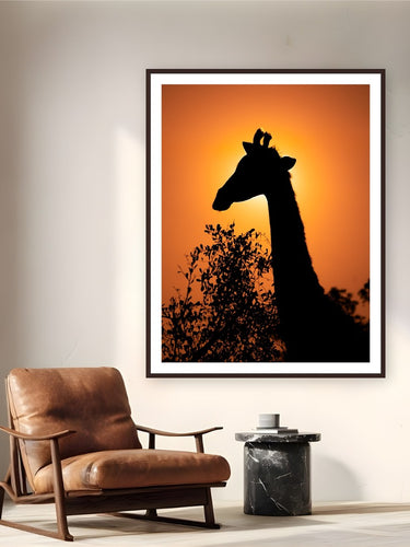 Giraffe Eclipse by Alex Wood from Sabi Sands Game Reserve, South Africa - framed black frame fine art photography displayed in a reading nook setting