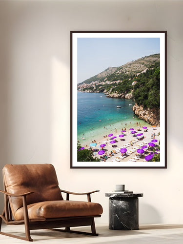 Black wood frame fine art print of Adriatic Summer by Ben Gamlin, Dubrovnik, Croatia, displayed on a reading nook wall — a summer afternoon on the Adriatic, just below Dubrovnik's limestone cliffs.