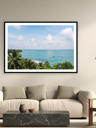 Black wood frame fine art print of Island Drift by Ben Gamlin, Mentawai Islands, Sumatra, displayed on a modern living room wall — the Mentawai Islands sit 150 kilometres off Sumatra's west coast — close enough to see from the hills, far enough that most of the world forgets they're there.