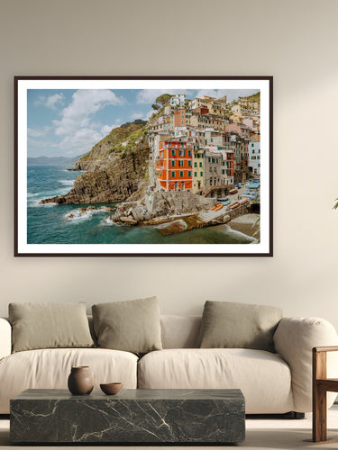 Riomaggiore by Bree Banning from Cinque Terre, Italy - framed black frame fine art photography displayed in a modern living room setting