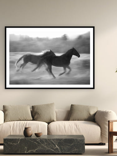 Black wood frame fine art print of Thunder Hooves by Brooklyn Phillips, Moran, Wyoming, displayed on a modern living room wall — triangle X is the only working dude ranch in America's entire National Park System — five generations of Turners running horses through Grand Teton since 1926.