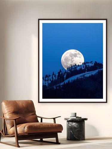 Bell's Full Moon by Sam Ferguson from Aspen, Colorado - framed black frame fine art photography displayed in a reading nook setting