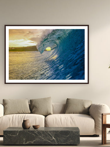 Black wood frame fine art print of Golden Hour Glass by Ben Gamlin, Central Coast, NSW, Australia, displayed on a modern living room wall — a sunrise barrel on the Central Coast, shot from inside the lineup.