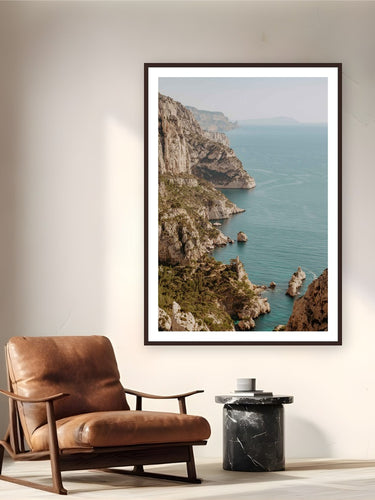 Les Calanques by Bree Banning from Marseille, France - framed black frame fine art photography displayed in a reading nook setting