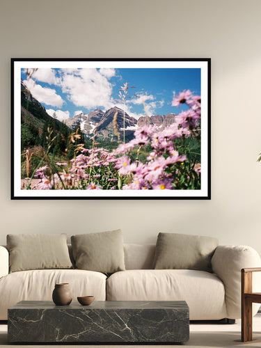 Black wood frame fine art print of Maroon Bells by Brooklyn Phillips, Aspen, Colorado, displayed on a modern living room wall — maroon Bells — twin fourteeners stained red by hematite in the mudstone, ten miles west of Aspen.