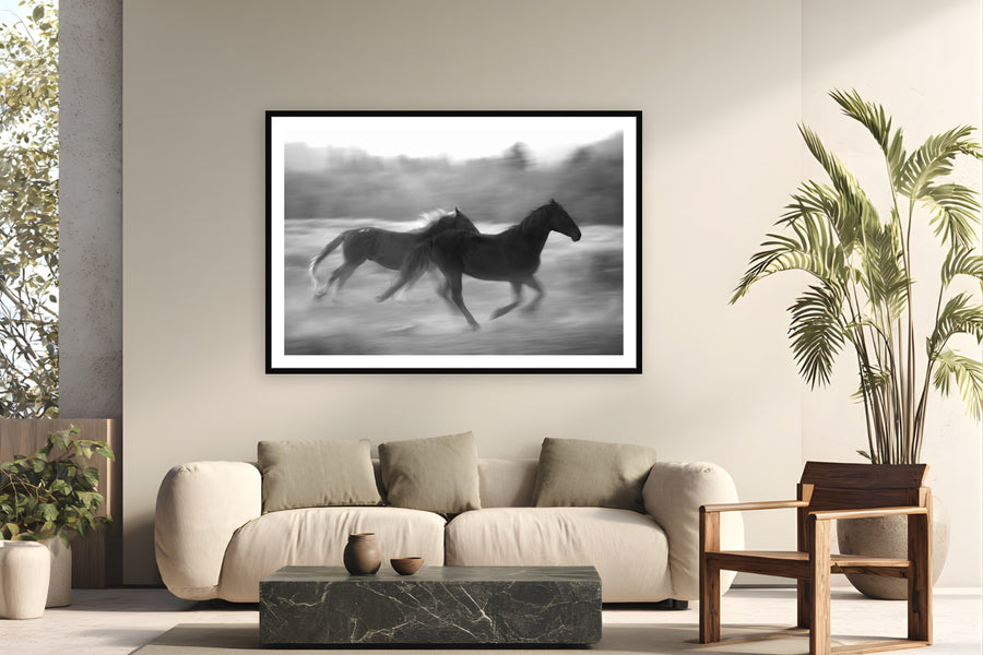 Black wood frame fine art print of Thunder Hooves by Brooklyn Phillips, Moran, Wyoming, displayed on a modern living room wall — triangle X is the only working dude ranch in America's entire National Park System — five generations of Turners running horses through Grand Teton since 1926.