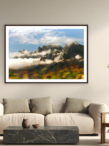 Moving Mountains by Devon Cardamone from Austria - framed black frame fine art photography displayed in a modern living room setting