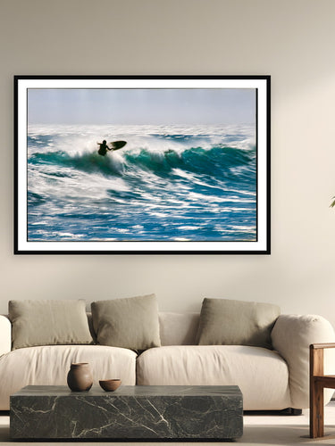 Black wood frame fine art print of Sunlit Motion by Devon Cardamone, Malibu, California, displayed on a modern living room wall — malibu on an overhead day — film grain turns the spray into motion rather than frozen detail.