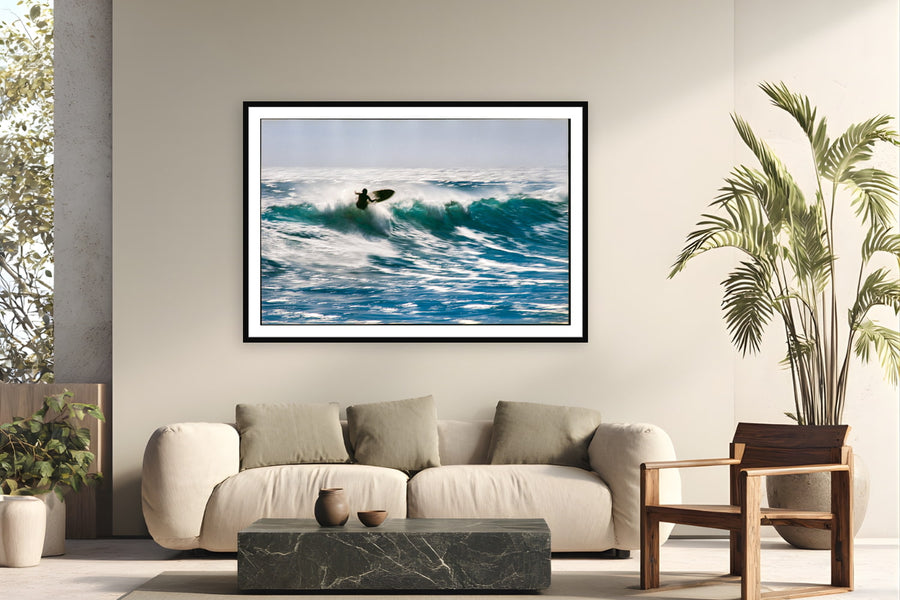 Black wood frame fine art print of Sunlit Motion by Devon Cardamone, Malibu, California, displayed on a modern living room wall — malibu on an overhead day — film grain turns the spray into motion rather than frozen detail.