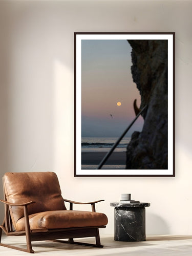 Red Moon by Jeremy Bishop from Pismo Beach, California - framed black frame fine art photography displayed in a reading nook setting