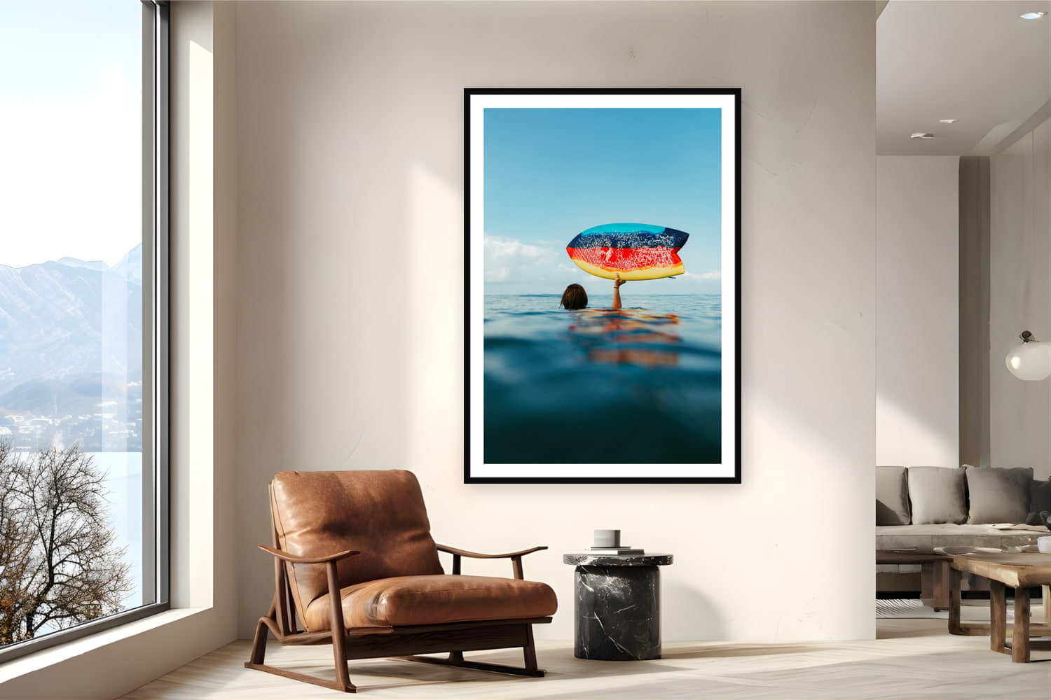 Black wood frame fine art print of Fishy by Sarah Swan, Mexico, displayed on a reading nook wall — between sets on a bigger swell day in Mexico — a rainbow fish board held overhead on a glassy sunrise morning.