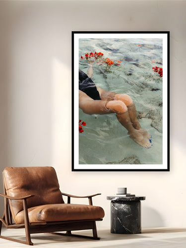 Black wood frame fine art print of Mermaid Tail by Sarah Swan, St. John, USVI, displayed on a reading nook wall — bougainvillea floating in the shallows of St. John on an early summer morning.