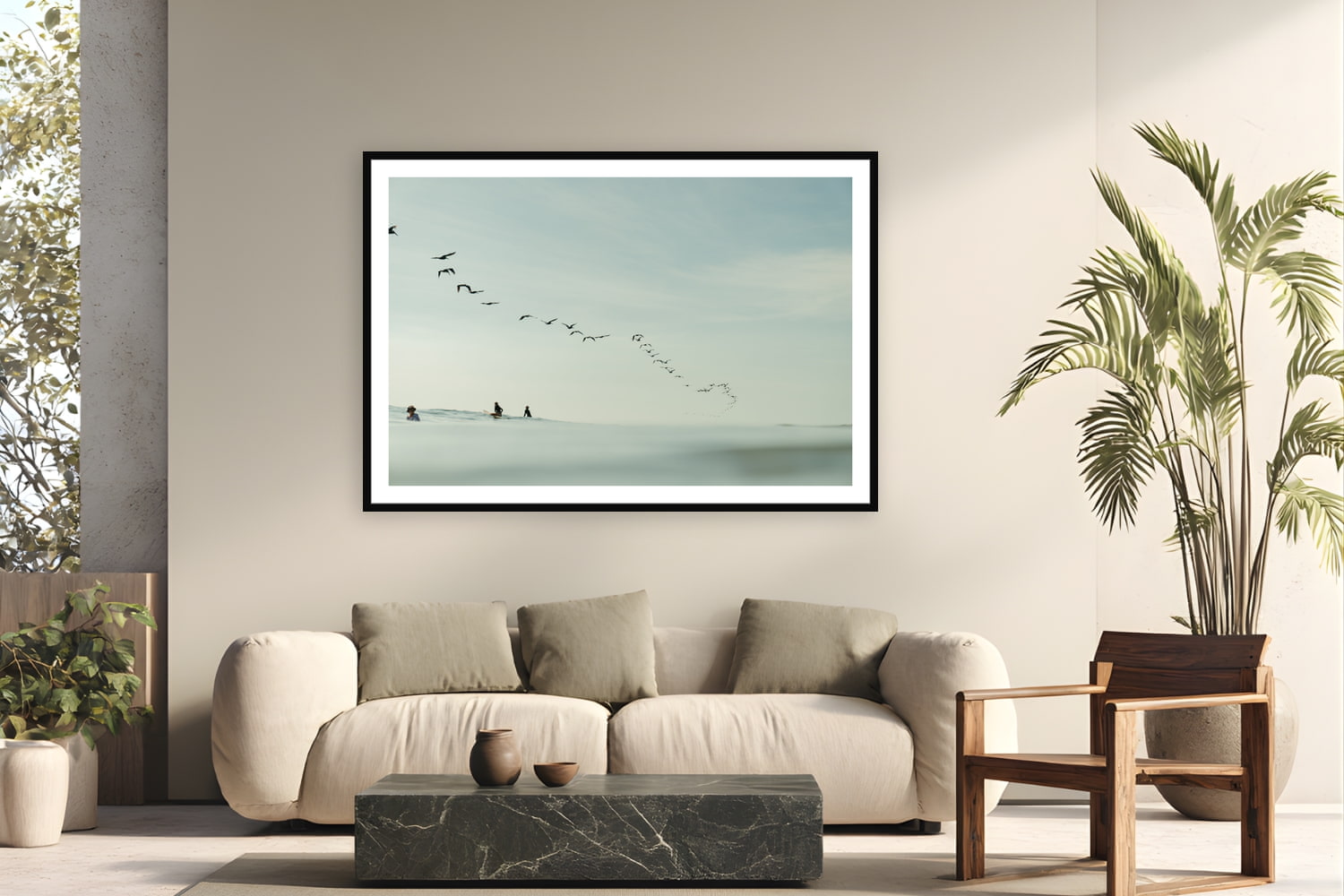 Black wood frame fine art print of Pelican Lineup by Sarah Swan, Costa Rica, displayed on a modern living room wall — a squadron of brown pelicans swept through the lineup in Costa Rica while three surfers waited for the last waves of the afternoon.