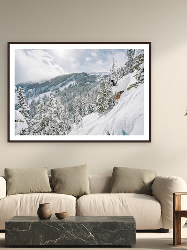 Pow Day by Tamara Susa from Snowmass, Colorado - framed black frame fine art photography displayed in a modern living room setting