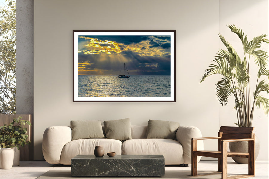 Black wood frame fine art print of Hawaiian Sunset by Tom Ingram, Maui, Hawai'i, displayed on a modern living room wall — sunset on the ʻAuʻau Channel between Maui and Lānaʻi — 'ʻauʻau' is Hawaiian for 'to take a bath,' a name earned by the channel's bathtub calm.